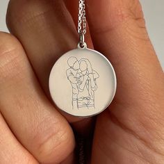 Create a one-of-a-kind treasure with our custom line art jewelry. Transform your cherished photo into a unique piece of art that you can wear close to your heart. Our skilled artists will create line art based on your provided photo, capturing the essence of your special memory. The artwork is then laser-engraved onto the pendant and hand-finished to perfection. Customize your pendant further by choosing a heartfelt text to engrave, tailored to the occasion. We'll send you a preview of your order to confirm the chosen design. This unique keepsake is ideal for commemorating birthdays, anniversaries, or any significant event. Create a beautiful tribute that will be cherished forever. Specification: Material: 14K pure Gold or 925 Sterling Silver Dimensions: 20 mm charm; 45 cm chain length *TH Artistic Personalized Round Necklace, Artistic Engraved Round Pendant Necklaces, Artistic Engraved Round Pendant Necklace, Artistic Personalized Necklace, Artistic Personalized Round Pendant Necklace, Artistic Jewelry For Valentine's Day Gift, Personalized Round Artistic Jewelry, Customizable Heart Pendant Necklace For Gift, Artistic Necklaces For Mother's Day Gift