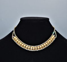 This is a beautiful mid century gold tone necklace with Aurora Borealis Rhinestones. The necklace is 15 inches plus the hook clasp. This necklace is unsigned but is a beautiful design and nice quality. It is in excellent vintage condition with no signs of wear to the gold tone metal and no missing AB stones. It will arrive in the black velvet pouch. Free shipping. Gold Costume Jewelry Necklace With Sparkling Stones, Formal Gold Rhinestone Necklace With Jewels, Vintage Gold Rhinestone Necklace For Parties, Vintage Gold Rhinestone Necklace With Sparkling Stones, Gold Rhinestone Costume Jewelry Necklace, Vintage Gold Rhinestone Necklace Gift, Formal Yellow Gold Rhinestone Necklaces, Velvet Pouch, Gold Tone Necklace