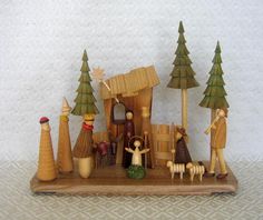 a nativity scene with figurines and trees