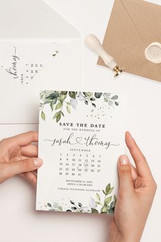 two hands holding up a save the date card next to an envelope with a calendar on it