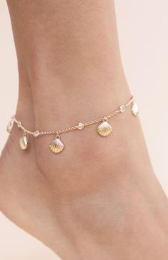 Online only! Add a touch of coastal elegance to your look with Ettika's Scallop Shell Anklet, featuring a delicate gold chain embellished with rhinestone details and charming seashell accents. The gold finish completes this stunning piece, perfect for enhancing your summer style.


	18k Gold Plated, Zinc, Glass Crystals
	8" with 1" extender
	Lobster Clasp Elegant Gold Shell Bracelets, Elegant Gold Strand Jewelry, Delicate Gold Bracelets For Summer, Delicate Gold Beach Jewelry, Adjustable Gold Strand Anklets, Gold Delicate Anklets For Summer, Delicate Gold Anklets For Summer, Elegant Gold-tone Beach Jewelry, Elegant Gold-tone Jewelry For Beach