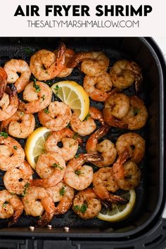 air fryer shrimp with lemon wedges and parsley on top in a pan