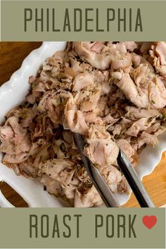 a white plate topped with meat next to a knife and fork