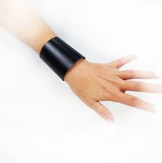 Cool black genuine Italian leather cuff bracelet, a beautiful gift idea for men and women! High bracelet: 2.55'' (6.5 cm) Adjustable closure with snap buottons Suitable for wrist measurement from 5.5'' to 7.5'' (14 / 19 cm) For other amazing gift ideas, please visit here: Napolilab.etsy.com  Made in Napoli with pride Elegant Black Wristlet For Gift, Modern Cuff Wristband As Gift, Black Cuff Leather Bracelet For Party, Black Leather Cuff Bracelet For Party, Modern Black Leather Bracelet For Gift, Black Minimalist Cuff Bracelet For Gift, Modern Black Leather Bracelet For Party, Black Minimalist Cuff Bracelet Gift, Minimalist Black Cuff Bracelet Gift