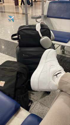 two pieces of luggage sitting next to each other on the floor at an airport terminal