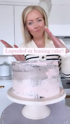 a woman standing in front of a cake with frosting on it and the caption is upside down