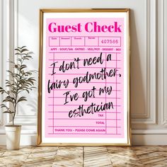 a pink poster with the words guest check written in black on it next to a potted plant