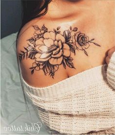 a woman with a flower tattoo on her chest