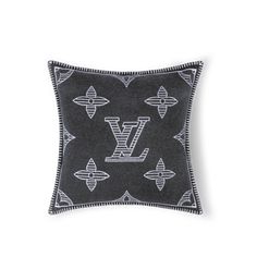 a black and white pillow with the letter v on it