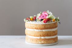 a cake with white frosting and flowers on top