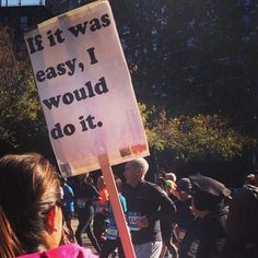 a woman holding a sign that says if it was easy, i would do it