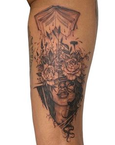 a woman's thigh with flowers and an open book on top of her head