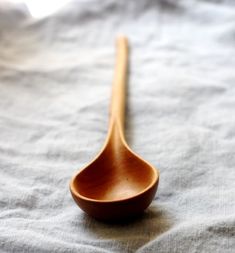 a wooden spoon sitting on top of a bed