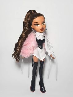 a doll with long brown hair and black boots