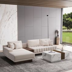 a modern living room with white couches and marble coffee table in front of large windows