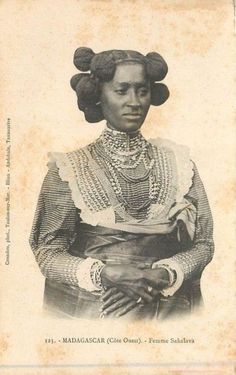 an old photo of a woman with braids on her head and wearing a dress