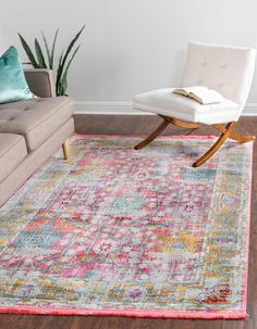 a living room with a couch, chair and rug