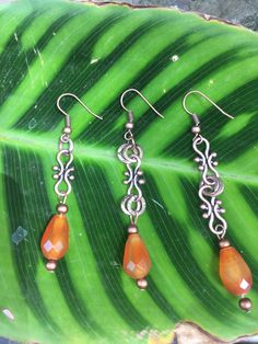 Beautiful faceted Garnet in a copper setting , comes in 3 styles , long, medium and short, or if you like a different gemstone message me Nickel-free Amber Colored Metal Jewelry, Spiritual Copper Drop Earrings, Nickel-free Amber Copper Jewelry, Elegant Orange Copper Earrings, Orange Metal Jewelry With Matching Earrings, Orange Copper Dangle Jewelry, Silver Spiritual Copper Earrings, Spiritual Silver-colored Copper Earrings, Amber Copper Earrings As Gift