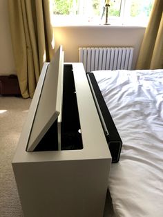 a bed with a white and black box on it