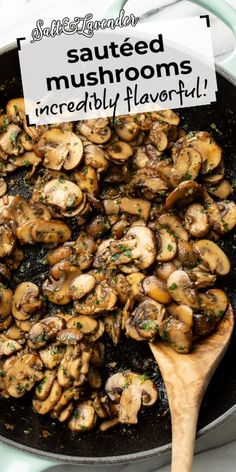 mushrooms are being cooked in a skillet with a wooden spatula on the side