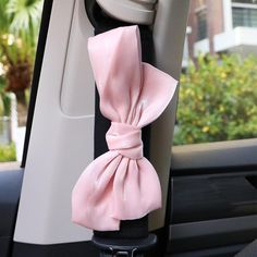 a pink bow tied to the back of a car