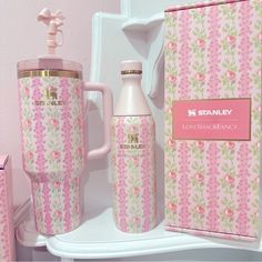 a pink and white floral pattern with gold accents is next to the starbucks coffee cup