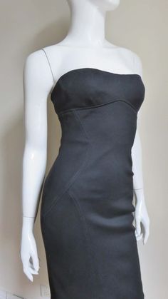 For Sale on 1stDibs - A fabulous black silk jersey strapless dress from Gianni Versace Couture. It is fitted with flattering seaming and the center back has functional on the Strapless Bodycon Bandage Dress For Formal Events, Sleek Fitted Strapless Dress For Gala, Black Strapless Corset Dress With Boning, Formal Fitted Strapless Dress, Sleek Fitted Strapless Sleeveless Dress, Strapless Bandage Dress With Boned Bodice For Evening, Fitted Strapless Dress For Formal Occasions, Sleek Fitted Strapless Dress For Cocktail, Sleek Fitted Strapless Dress For Cocktail Occasions