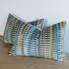 two pillows sitting on top of a wooden floor