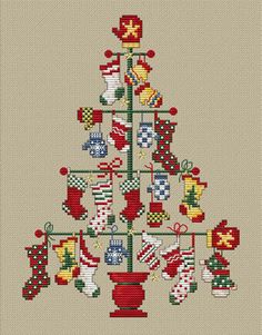 a cross stitch christmas tree with stockings hanging from it