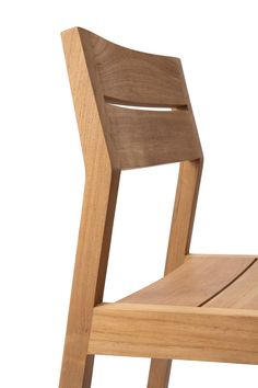 a wooden chair sitting on top of a white floor