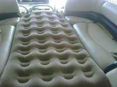 an inflatable mattress is sitting on the back of a car's passenger seat