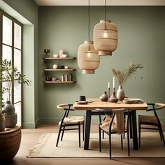 a dining room with green walls and wooden table surrounded by black chairs, hanging lights and potted plants