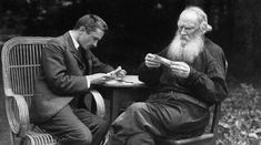 two men sitting at a table playing chess