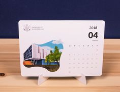 a desk calendar sitting on top of a wooden table