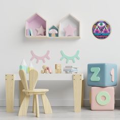 a child's room with toys and decor on the wall, including wooden blocks