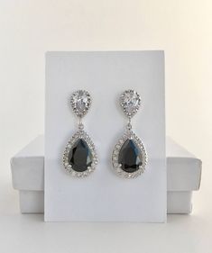 I've create this luxury black cubic zirconia bridal tear drop earrings in rhodium plated brass setting. Earrings feature a large teardrop with pear cut black cubic zirconia center surrounded by tiny round zirconia crystals. Teardrop dangles from a bright cubic zirconia ear stud. Total length of the earring is 3.5 cms. For matching necklace click: https://www.etsy.com/listing/520023845/black-cubic-zirconia-necklace-black?ref=shop_home_active_58 To browse my collection click : https://www.etsy.com Classic Black Wedding Earrings, Classic Black Earrings For Wedding, Formal Black Diamond Cubic Zirconia Earrings, Formal Earrings With Black Diamonds And Cubic Zirconia, Formal Cubic Zirconia Earrings With Black Diamonds, Black Teardrop Crystal Jewelry, Black Sparkling Stones Wedding Jewelry, Black Sparkling Stones Jewelry For Wedding, Black Jewelry With Sparkling Stones For Wedding