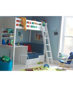 a child's bedroom with blue walls and white bunk beds