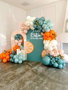 an arch made out of balloons and oranges