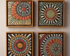 four framed art pieces with different designs on them