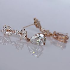 "Glamorous rose gold crystal earrings in a teardrop style will add sweet sparkle to your wedding day. Marquise zircon crystals in a petal cluster design are completed with a Swarovski crystal teardrop. Set in 16K rose gold tarnish free plate. Comfortable, light, and very sassy - they are a beautiful mid length earring. Annie is perfect for the elegant bride. Length : approx 1.25\" (3.2 cm) Nickel free & allergy free posts. High quality cubic zircons set in 16K rose gold plate. 💟 Items that Rose Gold Diamond Crystal Earrings For Wedding, Rose Gold Cubic Zirconia Diamond Earrings For Wedding, Glamorous Rose Gold Cubic Zirconia Bridal Earrings, Rose Gold Diamond Bridal Earrings For Wedding, Rose Gold Drop Bridal Earrings For Anniversary, Rose Gold Drop Bridal Earrings, Rose Gold Cubic Zirconia Drop Bridal Earrings, Dazzling Rose Gold Cubic Zirconia Bridal Earrings, Elegant Rose Gold Teardrop Earrings For Anniversary