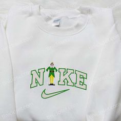 Introducing the Buddy Elf x Nike Embroidered Shirt, the perfect blend of style and holiday spirit. Made with premium quality materials, this shirt showcases the iconic Buddy Elf character, embroidered with precision and attention to detail. With its comfortable fit and vibrant colors, it’s the ideal attire for any Christmas gathering or movie night. As for our Christmas Movie Embroidered Hoodie, it’s a must-have for all film enthusiasts. Crafted with soft, cozy fabric, it features intricate embroidery of beloved Christmas movie characters, bringing a touch of nostalgia to your wardrobe. Stay warm and stylish throughout the holiday season with this Nike Cartoon, Bff Hoodies, Disney Character Shirts, Nike Hoodies, Nike Inspired, Crewneck Embroidery, Sweatshirt Ideas, Cute Nike Outfits, Nike Crewneck