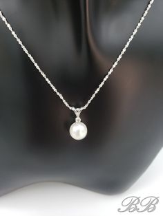 A timeless classic! This listing is for a 925 unplated sterling silver natural white freshwater cultured pearl necklace with a moissanite accent stone. Made to order. Please allow 3 weeks for the production of your necklace. Included in this purchase is a 1mm sterling silver chain in the style and length of your choosing. This necklace can be customized with any pearl color & size, or accent gemstone combination. Just message me for a quote =) Stone Dimensions 8MM Pearl, 2mm Round Moissanite *Li Classic Silver Pearl Jewelry, Classic Silver Pearl Chain Necklace, Elegant Silver Pearl Necklace With Pendant, White Akoya Pearl Round Pendant Necklace, Classic Sterling Silver Pearl Drop Jewelry, Classic Sterling Silver Pearl Necklace With Charm, Elegant Pearl White Sterling Silver Pearl Necklace, White Gemstone Solitaire Necklace, Elegant Sterling Silver Solitaire Necklace With Round Pendant