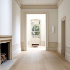 an empty room with white walls and wood flooring is pictured in this image from the front door