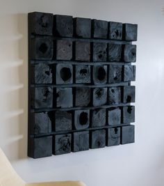 a black wall hanging on the side of a white wall