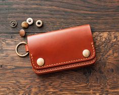 This small leather keychain wallet with coin pocket has the features and benefits of a large wallet, but it's very compact and fits easily in a pants pocket or small bag.  The wallet  is handmade of vegetable tanned Buttero (Walpier tannery, Italy) leather. This minimalist key chain wallet is designed so that your credit cards are completely enclosed in leather. There are no cutouts or holes in the design. In this wallet cardholder you need to pry the card with your finger to get it out, it's not difficult. But no one will see the code of your credit card and it will not be scratched by the keys, which is possible in cardholders with holes in the design. You can use this wallet card holder as a keychain, or attach a chain or strap to it to carry it in your hand. The ring can also be used t Leather Coin Purse With Key Clip As Gift, Leather Coin Purse With Key Clip For Gift, Leather Rectangular Coin Purse With Key Clip, Leather Wallet With Key Clip For Daily Use, Leather Wallets With Key Clip For Daily Use, Daily Use Leather Wallet With Key Clip, Leather Brown Coin Purse With Key Clip, Brown Leather Coin Purse With Key Clip, Leather Wallets With Interior Key Chain Holder