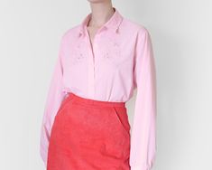 "baby pink embroidered shirt floral pattern, eyelet details, beautiful collar 65 % polyester 35% cotton 25.9\" long, 24.4\" pit to pit, 25.5\" sleeves 66 cm long, 62 cm pit to pit, 65 cm sleeves (model wears size S - M, height 175 cm, 5 ft 9 ins) measurements are taken while items are laying flat, for best fitting compare measurements to a garment that you wear in great vintage condition please do not hesitate to send me a message if you have any questions about this listing" Feminine Cotton Shirt For Spring, Feminine Embroidered Blouse For Work, Feminine Embroidered Workwear Blouse, Pink Embroidered Feminine Blouse, Pink Feminine Embroidered Blouse, Fitted Floral Embroidery Shirt For Workwear, Pink Floral Embroidered Shirt For Spring, Spring Embroidered Pink Blouse, Pink Floral Embroidery Summer Shirt