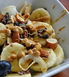 a white bowl filled with fruit and nuts