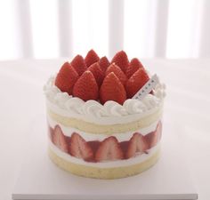 there is a cake with strawberries on top