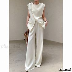 Olivia Mark - Chic and Stylish Two-Piece Ensemble with Unique Design - Sleeveless Top and Wide Leg Pants with Floor-length Hem Casual Fitted Sleeveless Pantsuit, Sleeveless Solid Color Pantsuit For Spring, Sleeveless Spring Pantsuit With Pockets, Casual Sleeveless Workwear Sets, Sleeveless Pantsuit With Pockets For Spring, Casual Sleeveless Sets For Workwear, Sleeveless Solid Color Workwear Pantsuit, Solid Sleeveless Pantsuit For Work, Casual Solid Color Sleeveless Pantsuit