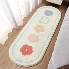 a white rug with colorful flowers on it